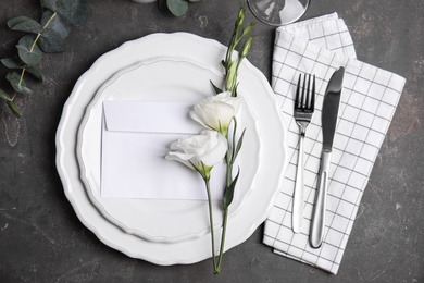 Elegant festive table setting on dark grey background, flat lay