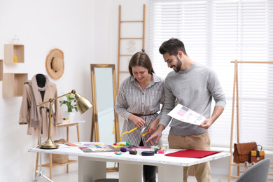 Photo of Fashion designers creating new clothes in studio