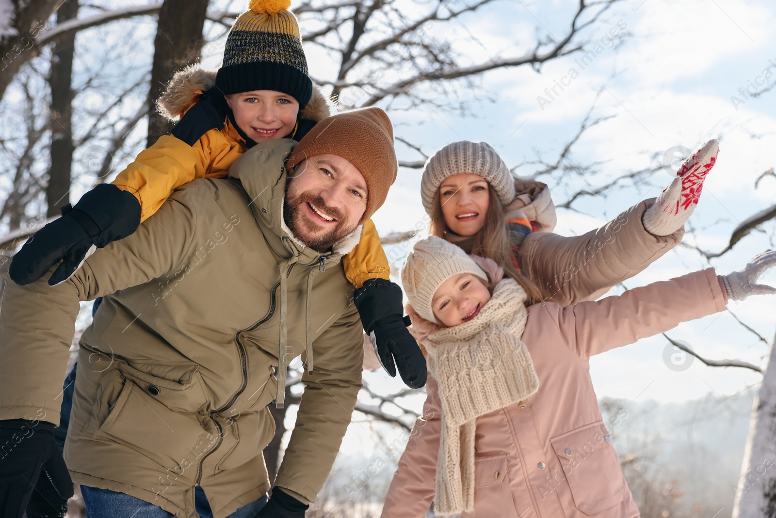 Photo of Happy family having fun in snowy forest