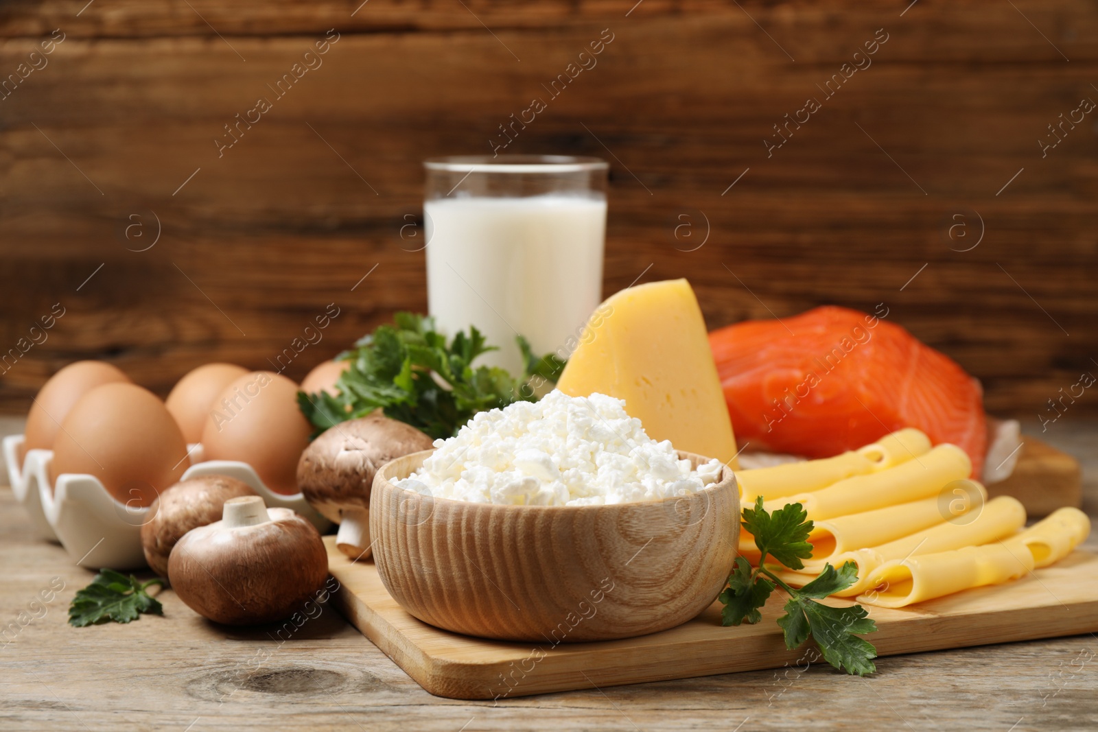 Photo of Fresh products rich in vitamin D on wooden table