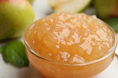 Photo of Delicious pear jam in glass bowl on table, closeup