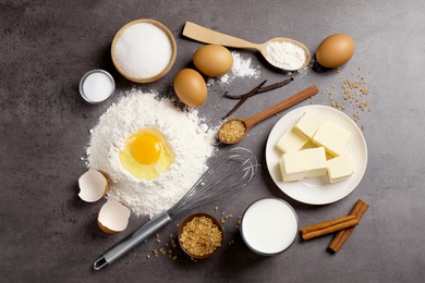 Photo of Flat lay composition with fresh ingredients for delicious homemade cake on grey table