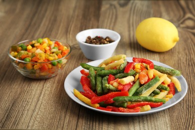 Photo of Mix of different frozen vegetables on wooden table, closeup