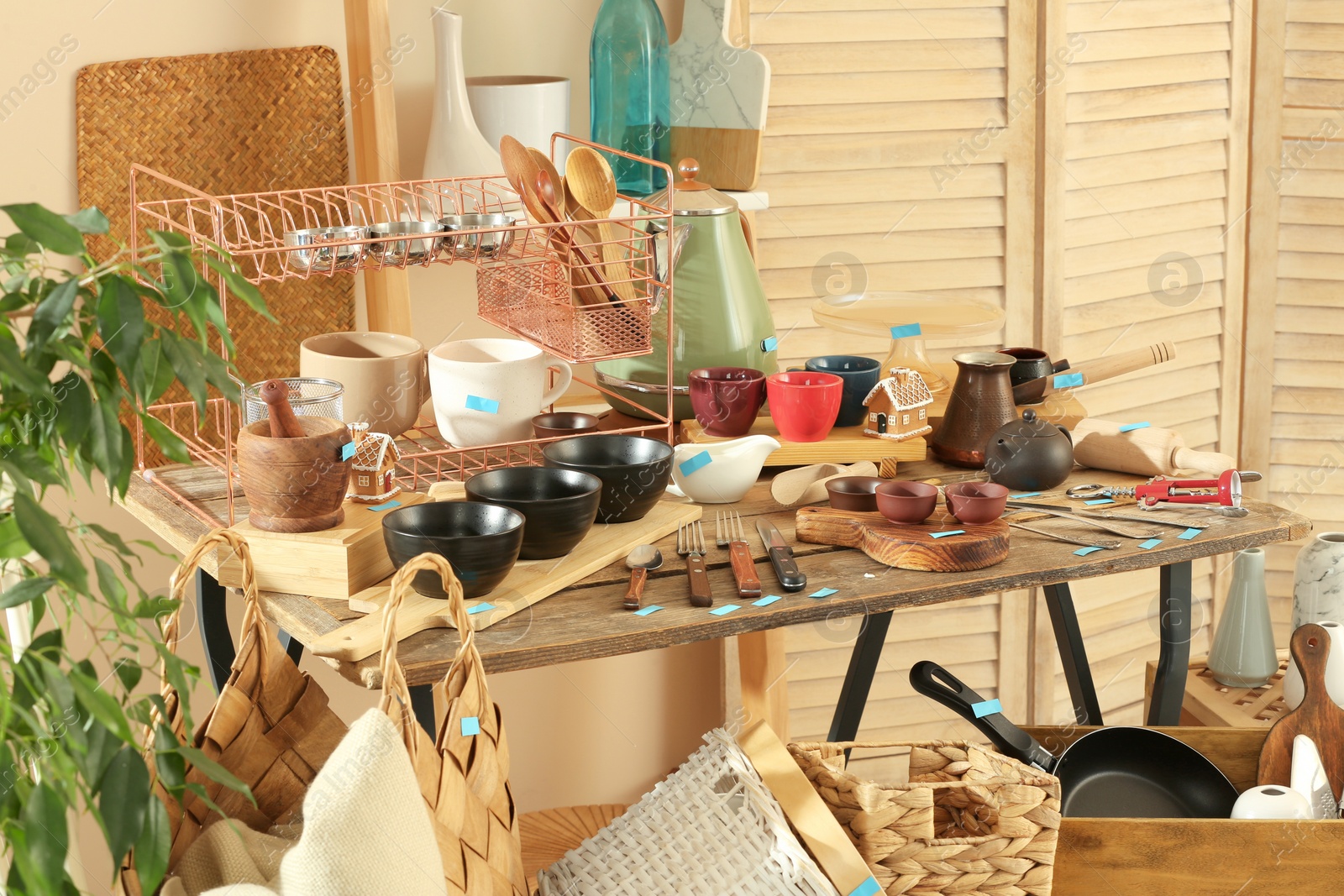 Photo of Many different cooking utensils in room. Garage sale