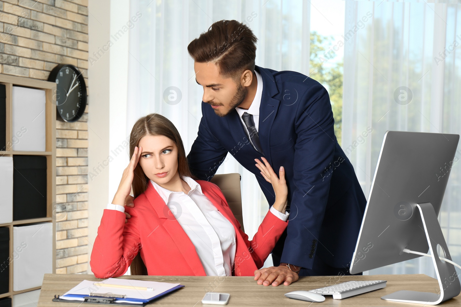 Photo of Boss molesting his female secretary in office. Sexual harassment at work