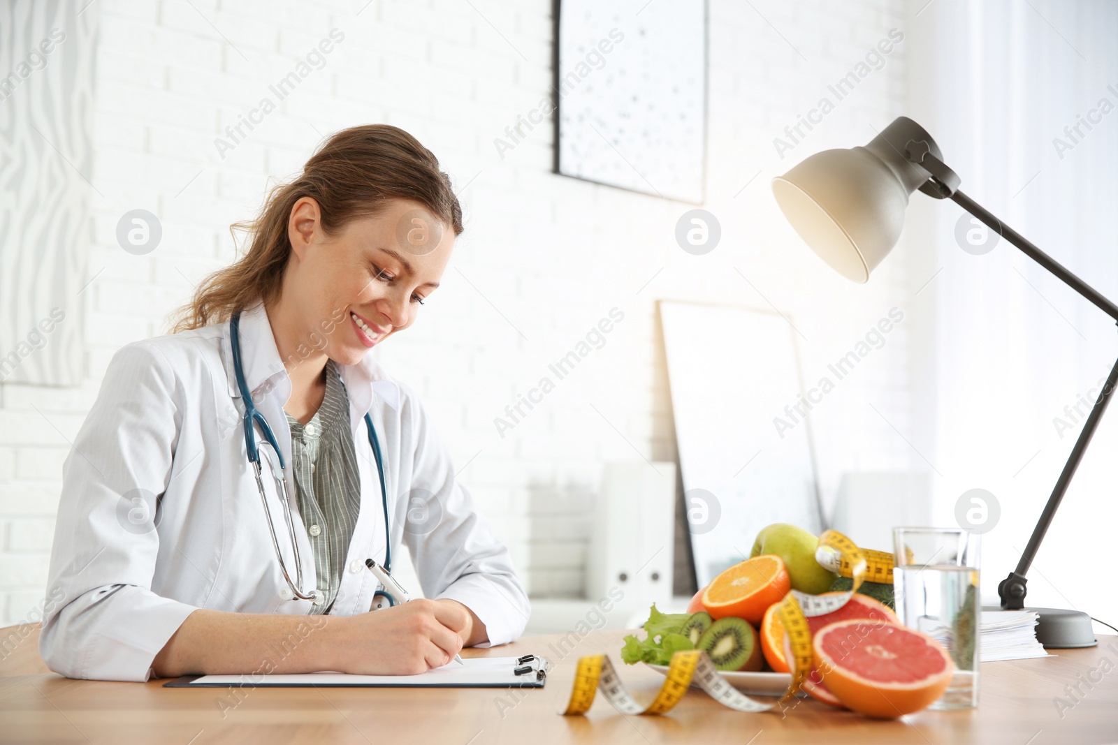 Photo of Female nutritionist working at desk in office