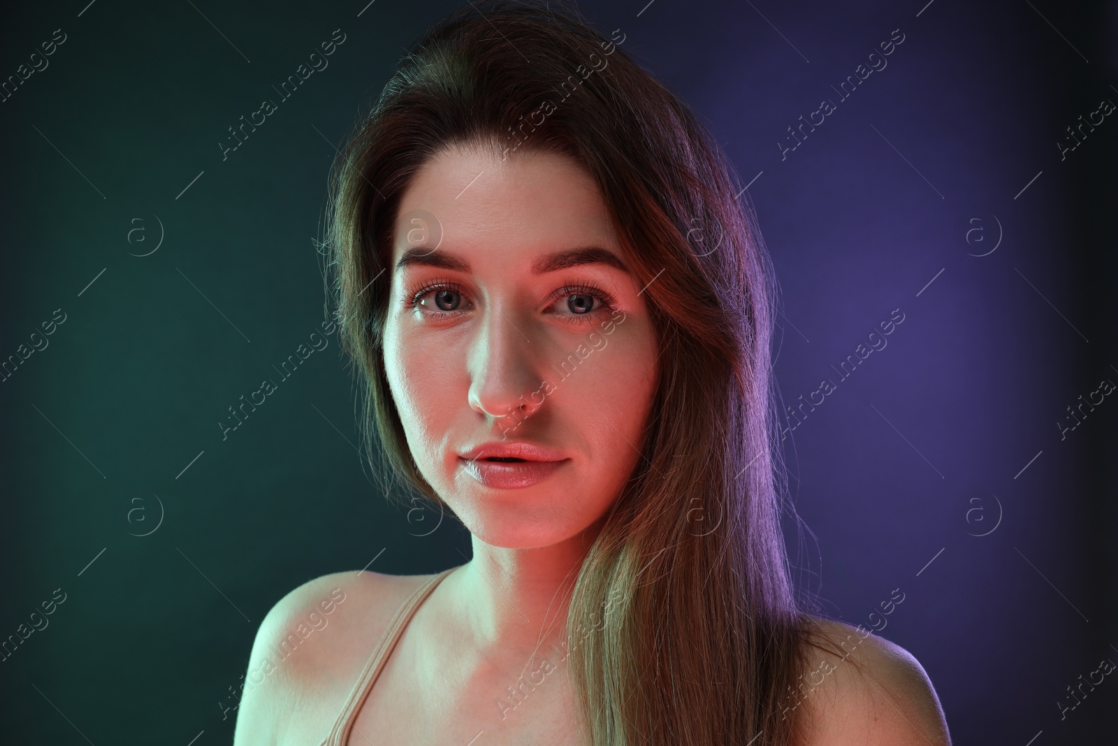 Photo of Portrait of beautiful young woman on color background