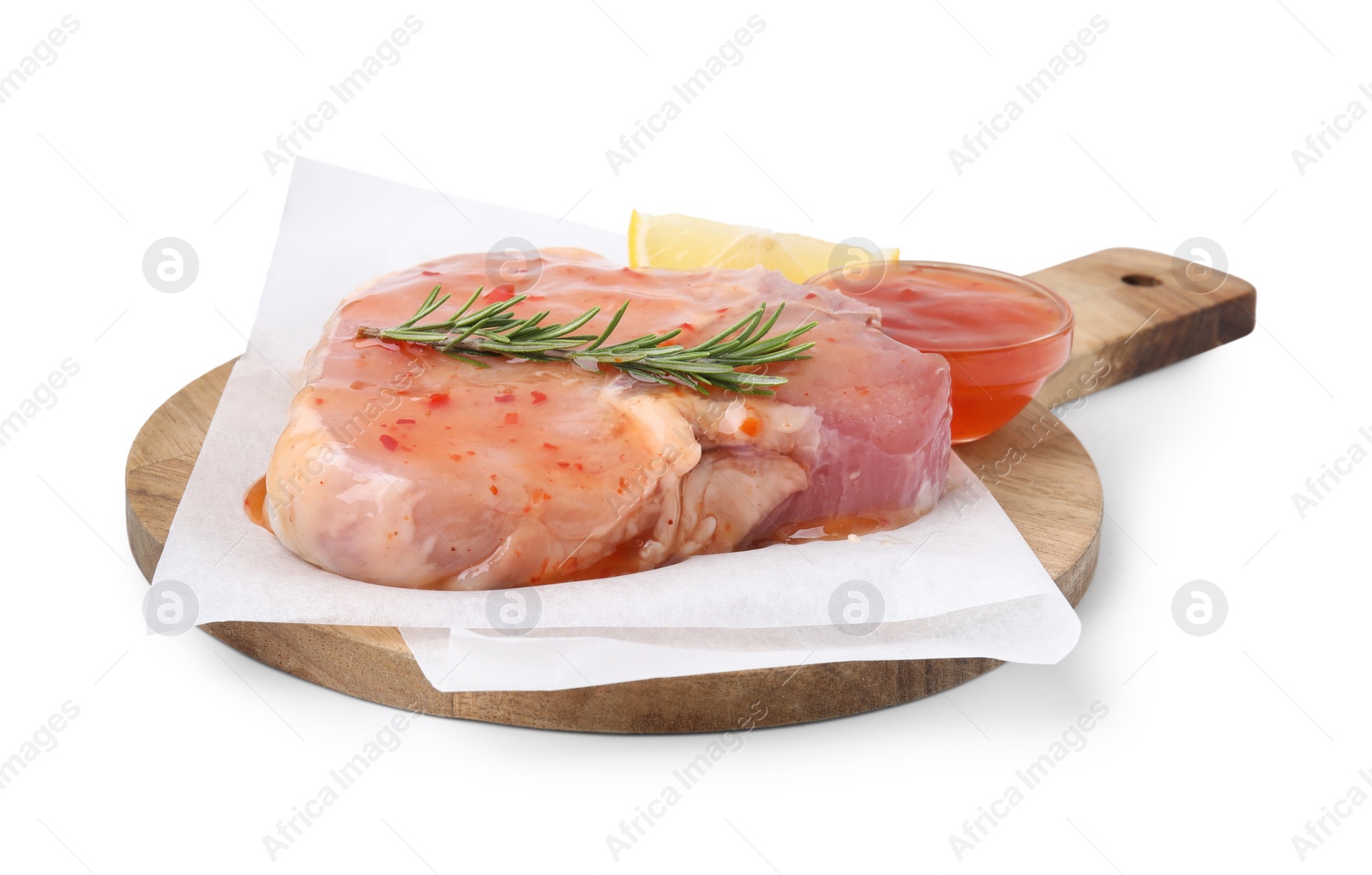 Photo of Board with raw meat, marinade, lemon and rosemary isolated on white