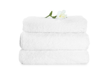 Terry towels and freesia flower isolated on white