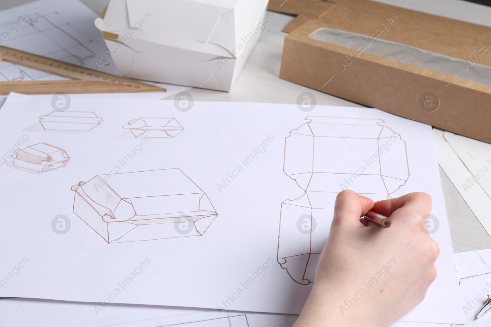 Photo of Woman creating packaging design at table, closeup