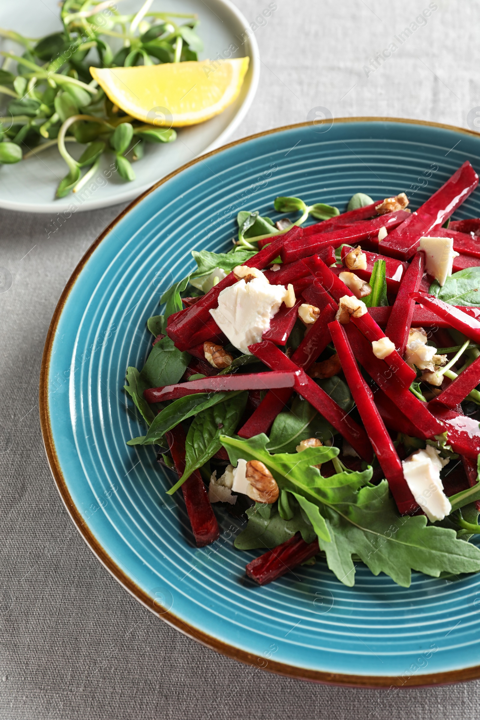 Photo of Plate with delicious beet salad served on table