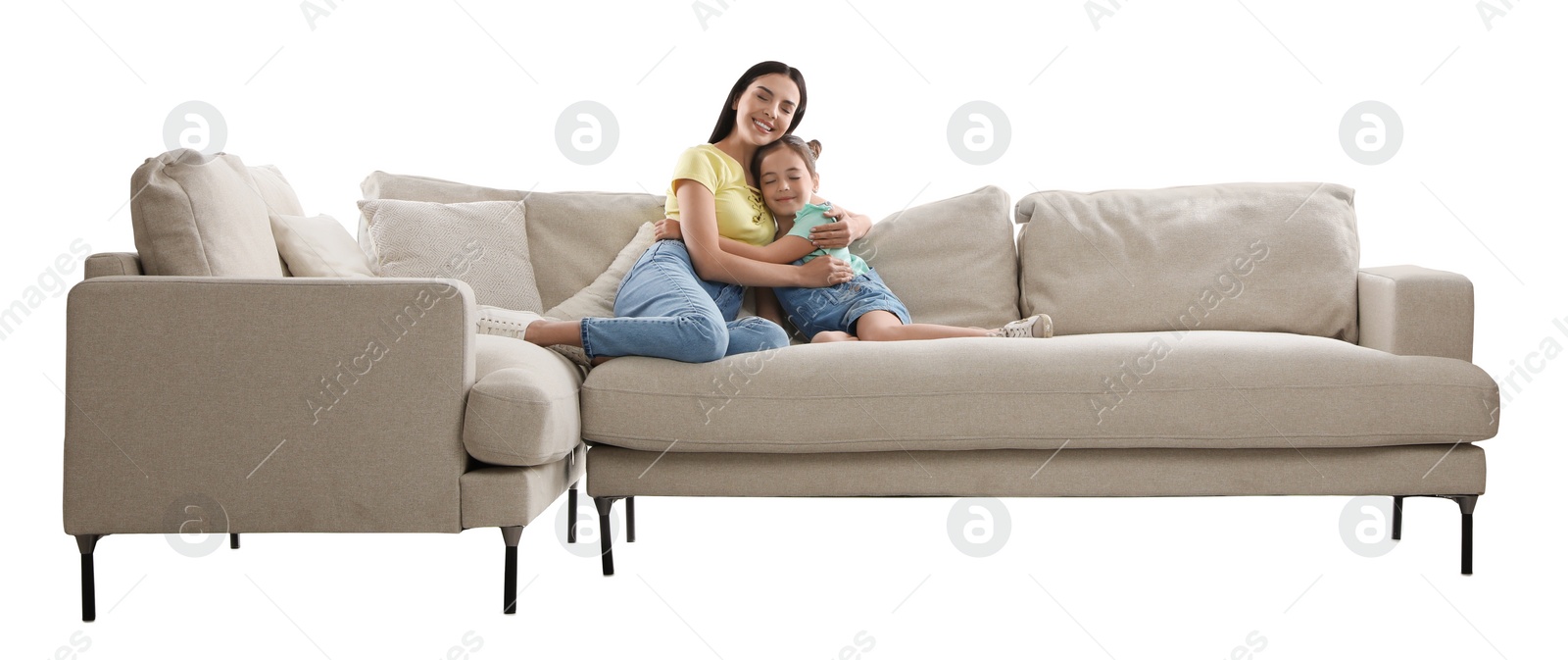 Photo of Young woman and her daughter resting on comfortable sofa against white background