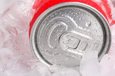 Photo of Energy drink in wet can and ice cubes, closeup
