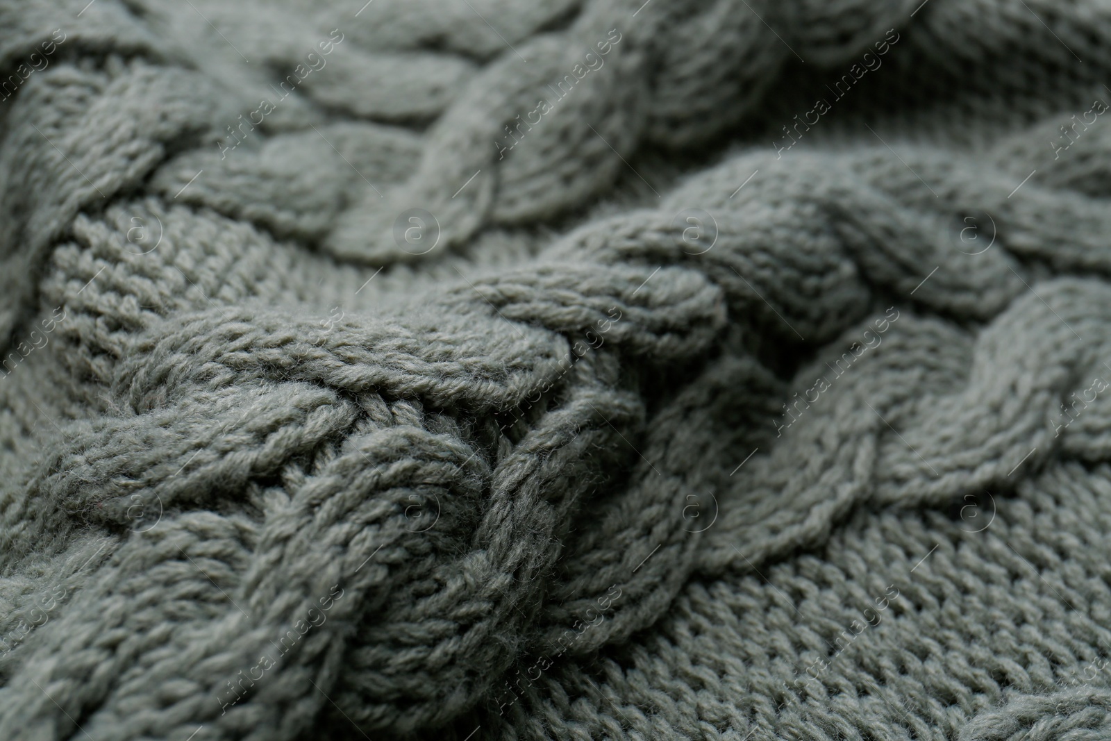 Photo of Knitted fabric with beautiful pattern as background, closeup