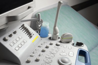 Photo of Ultrasound control panel and examination table in hospital, closeup