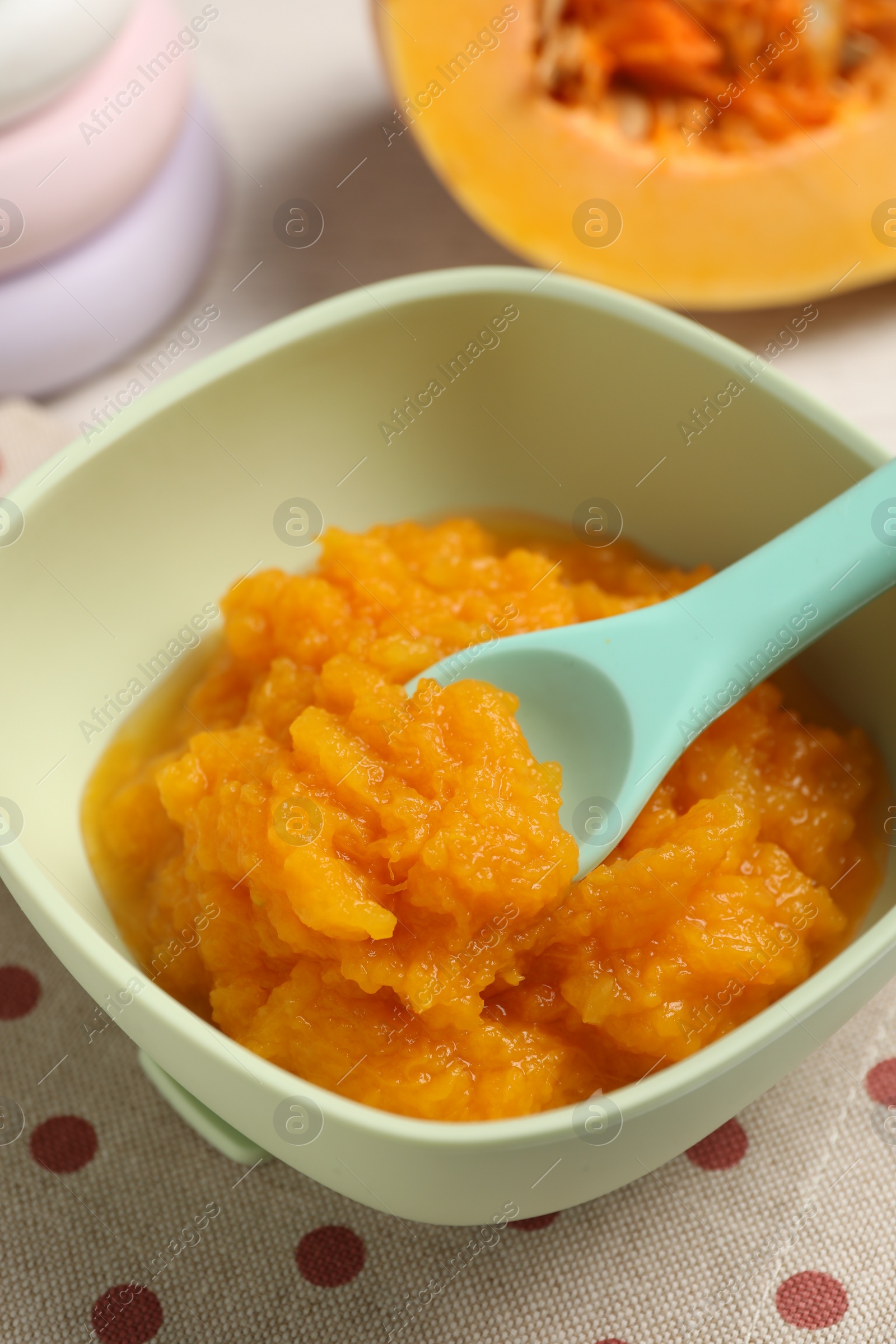 Photo of Baby food. Tasty pumpkin puree on table, closeup