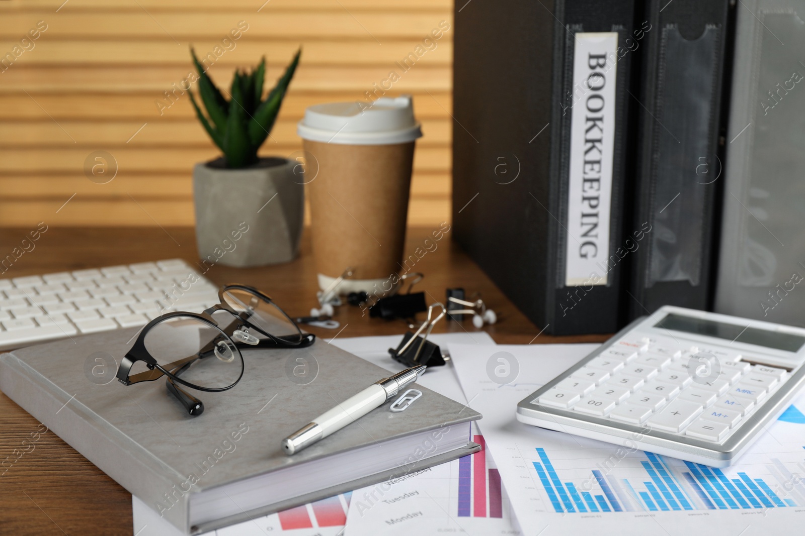 Photo of Bookkeeper's workplace with folders and documents on table