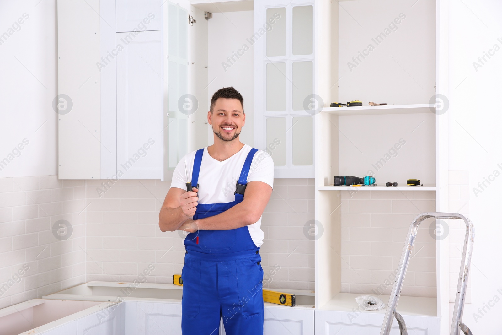 Photo of Portrait of worker with screwdriver in kitchen