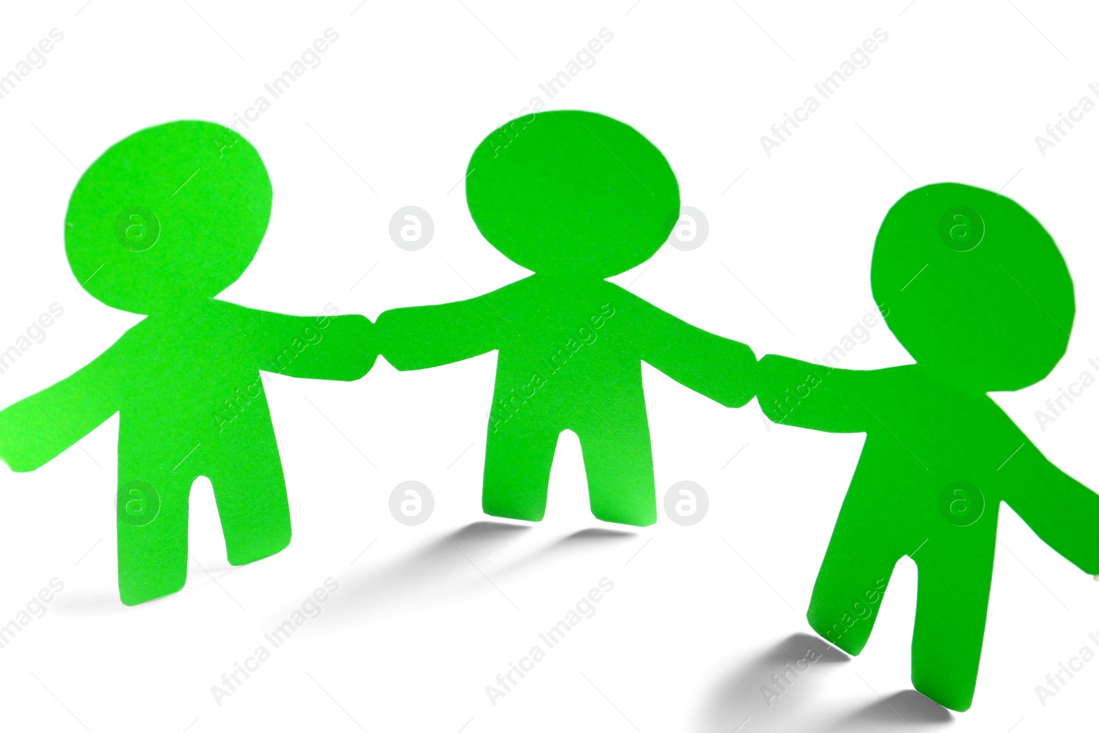 Photo of Paper people holding hands on light background. Unity concept