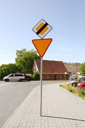 Different road signs on city street. Traffic rules