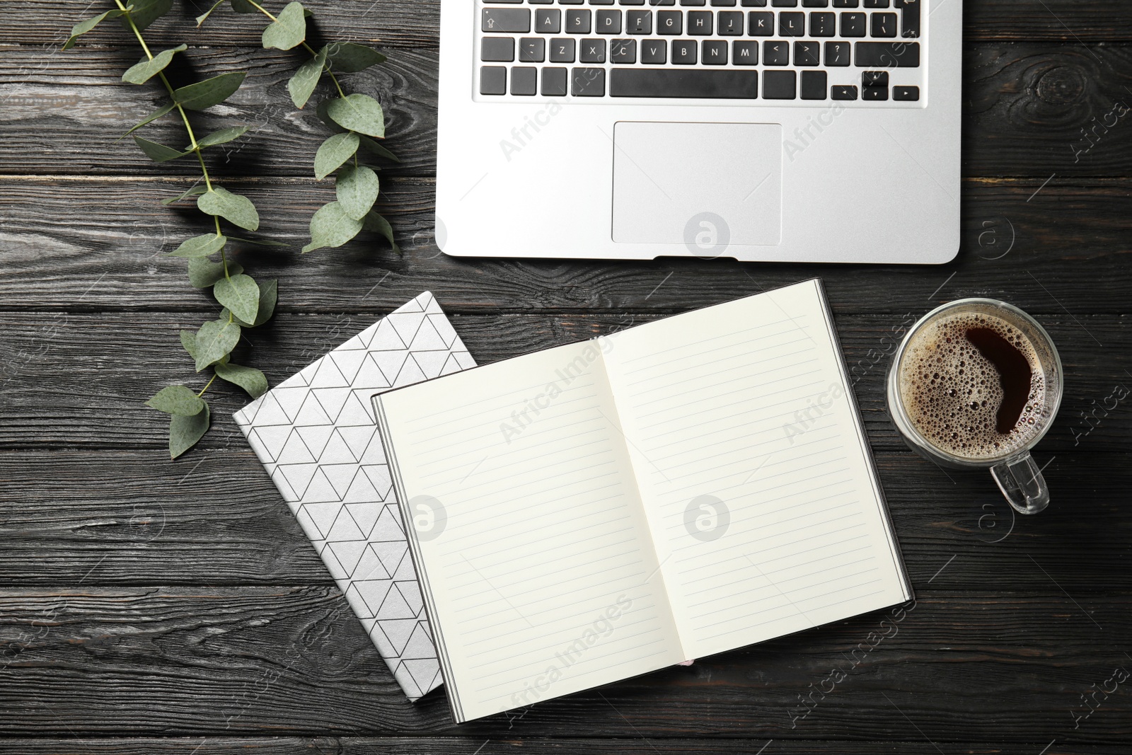 Photo of Flat lay composition with laptop and notebook on wooden table, space for text. Blogger's workplace