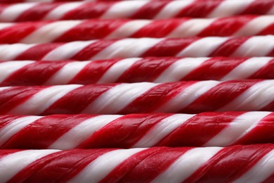 Photo of Many sweet Christmas candy canes as background, closeup