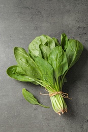 Bunch of fresh green healthy spinach on grey table, top view