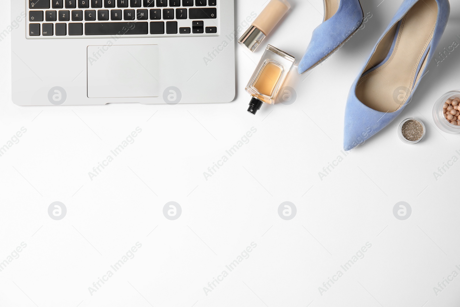 Photo of Flat lay composition with female accessories and laptop on white background. Beauty blogger's workplace