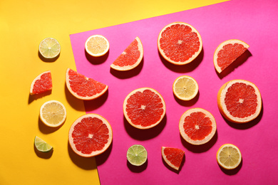 Flat lay composition with tasty ripe grapefruit slices on color background