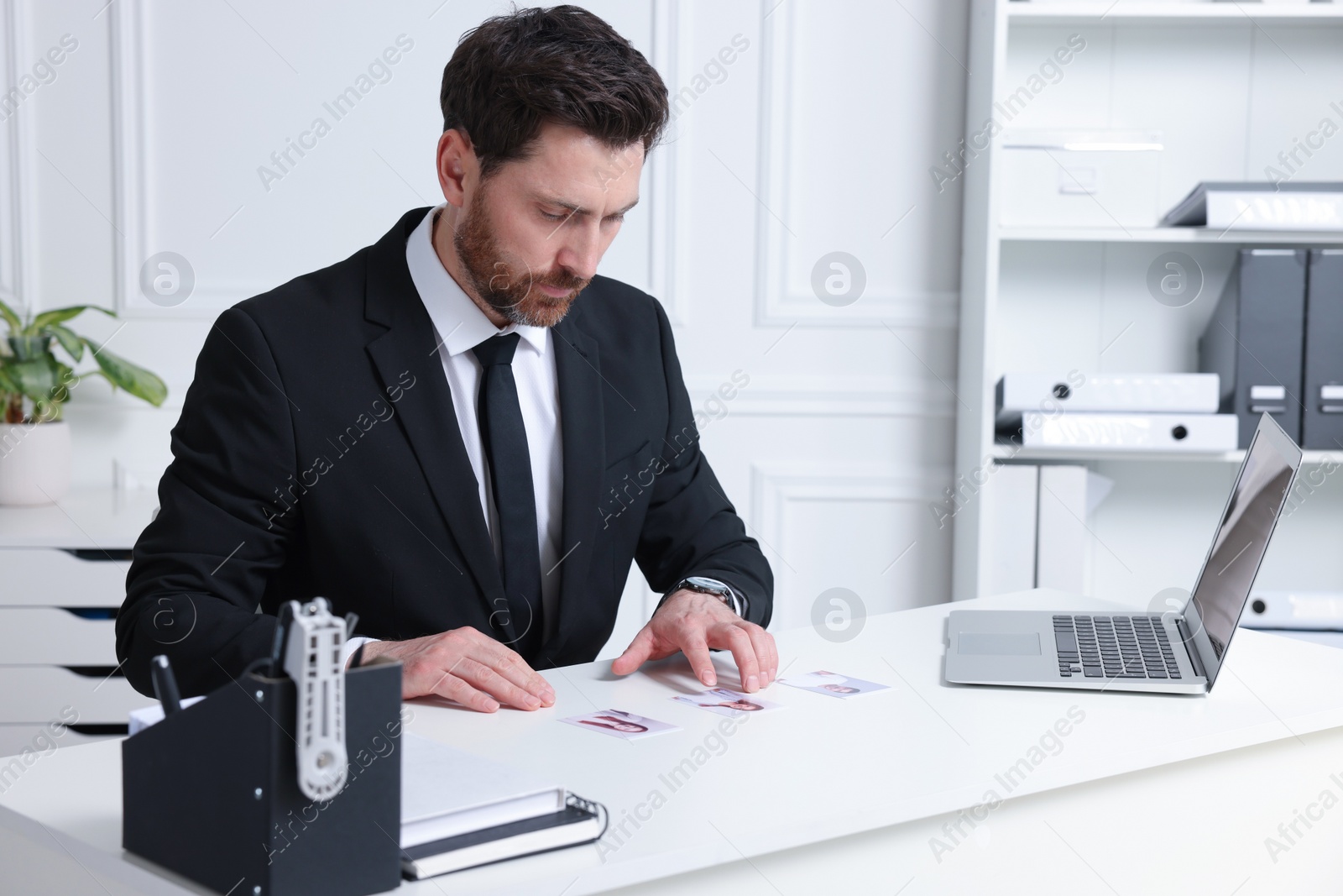 Photo of Human resources manager choosing employee among different applicants in office