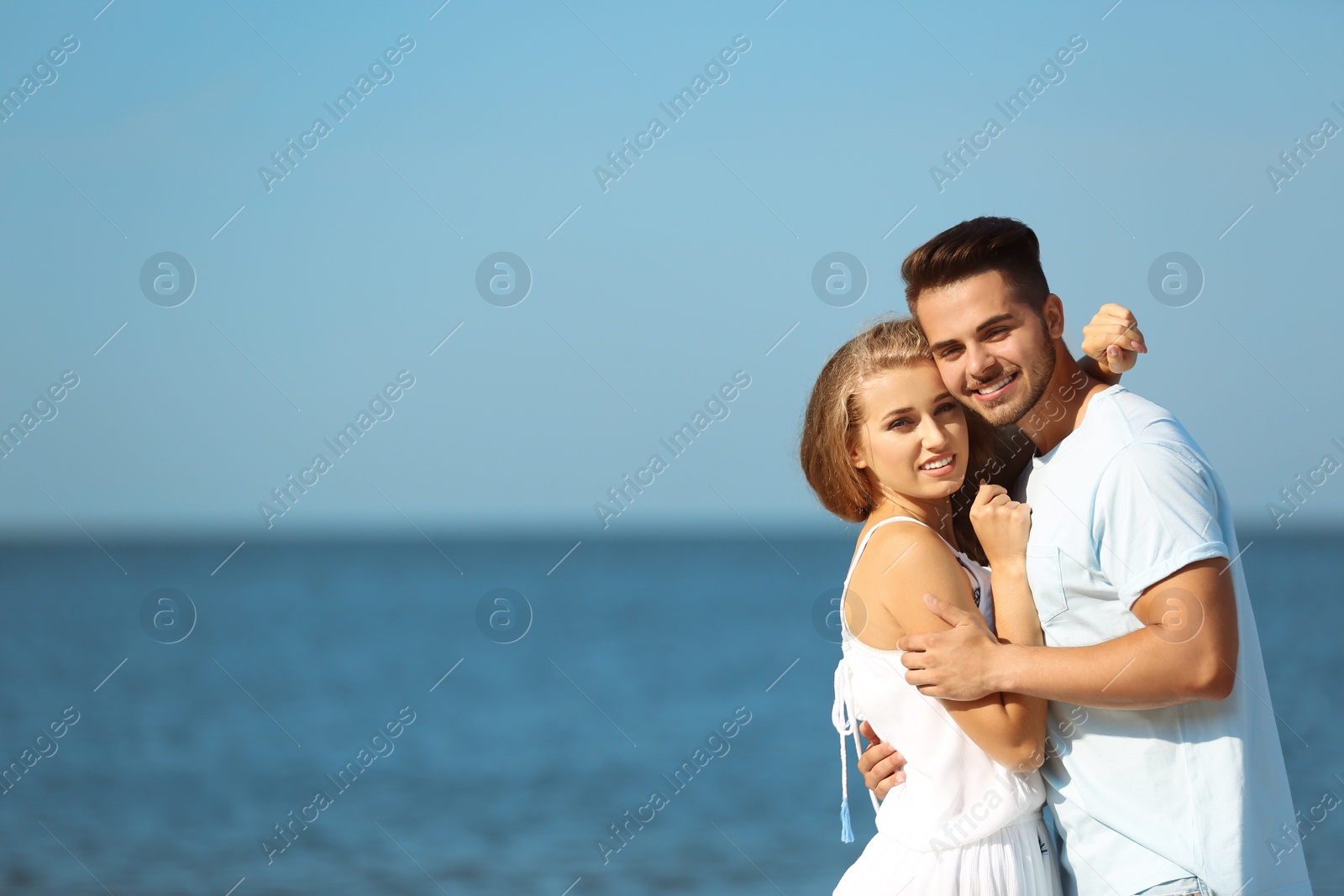 Photo of Happy young couple at beach on sunny day