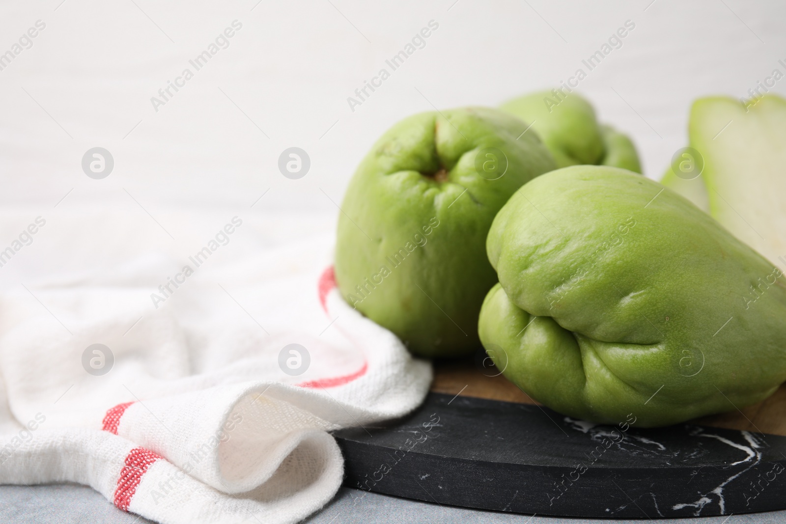 Photo of Fresh green chayote on table, closeup. Space for text