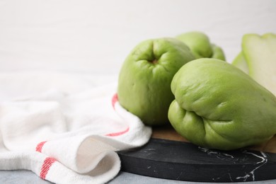 Fresh green chayote on table, closeup. Space for text