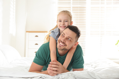 Photo of Dad and daughter spending time together at home. Happy Father's Day