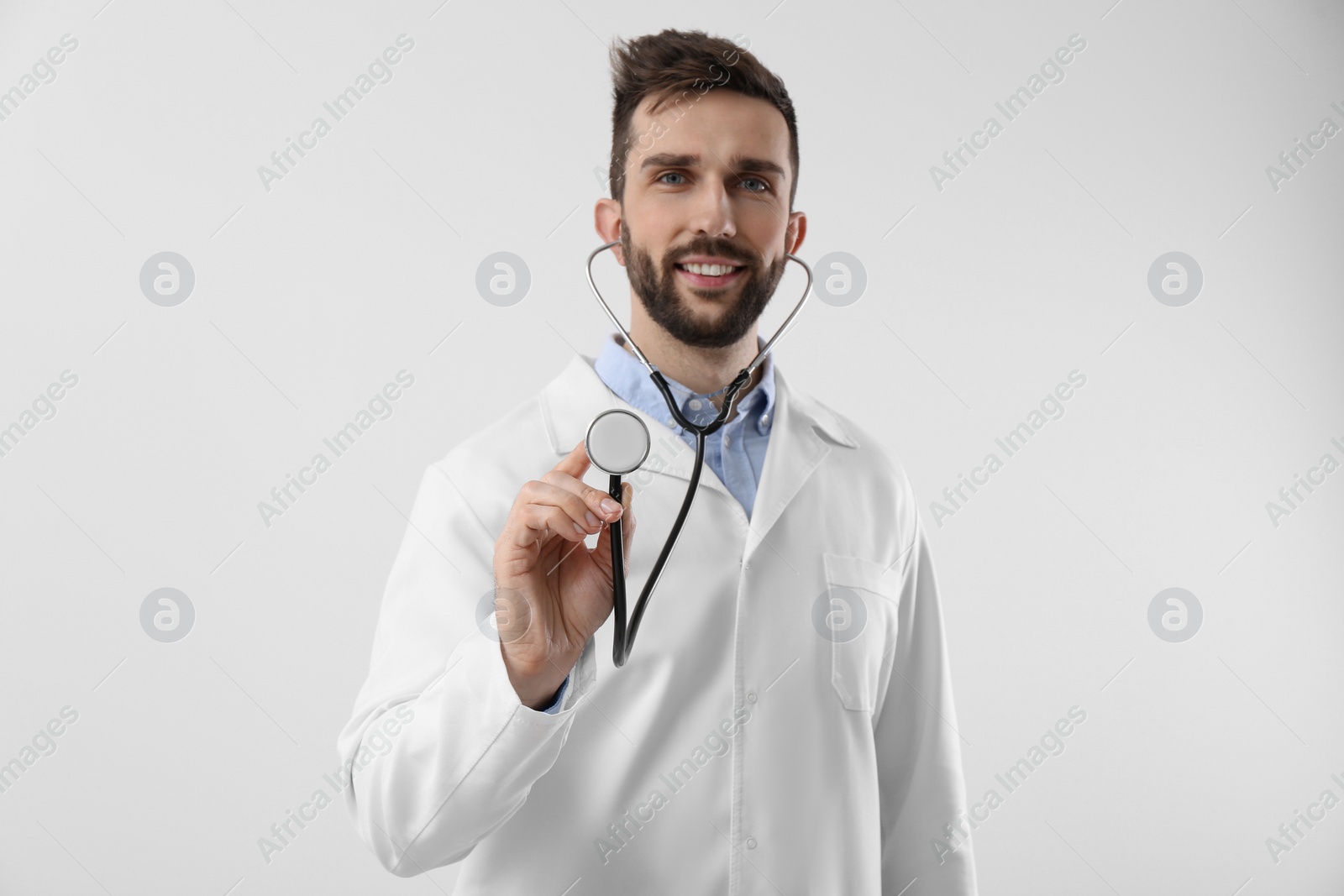 Photo of Doctor with stethoscope on white background. Cardiology concept