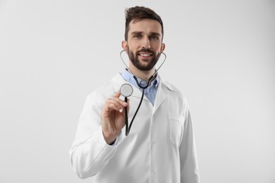 Photo of Doctor with stethoscope on white background. Cardiology concept