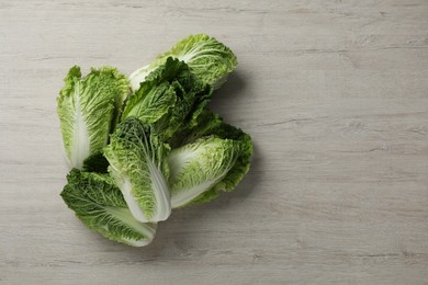 Fresh ripe Chinese cabbages on white wooden table, flat lay. Space for text