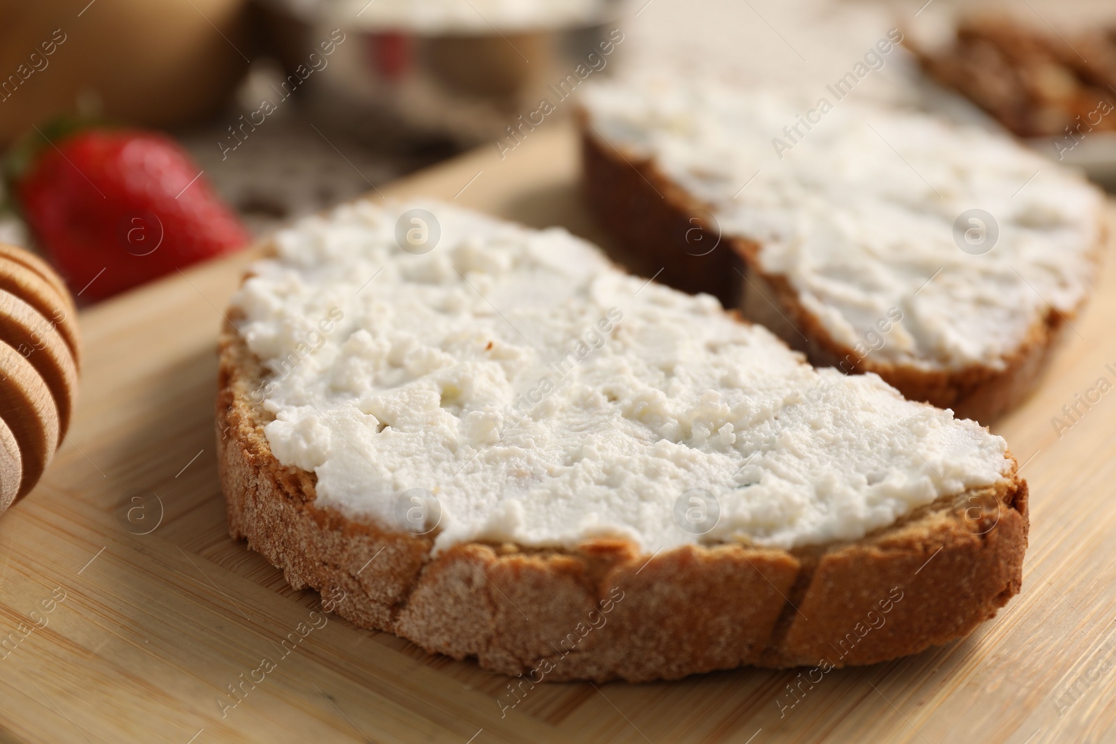 Photo of Delicious ricotta bruschettas and products on table, closeup