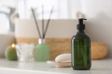 Photo of Green soap dispenser on white countertop in bathroom. Space for text