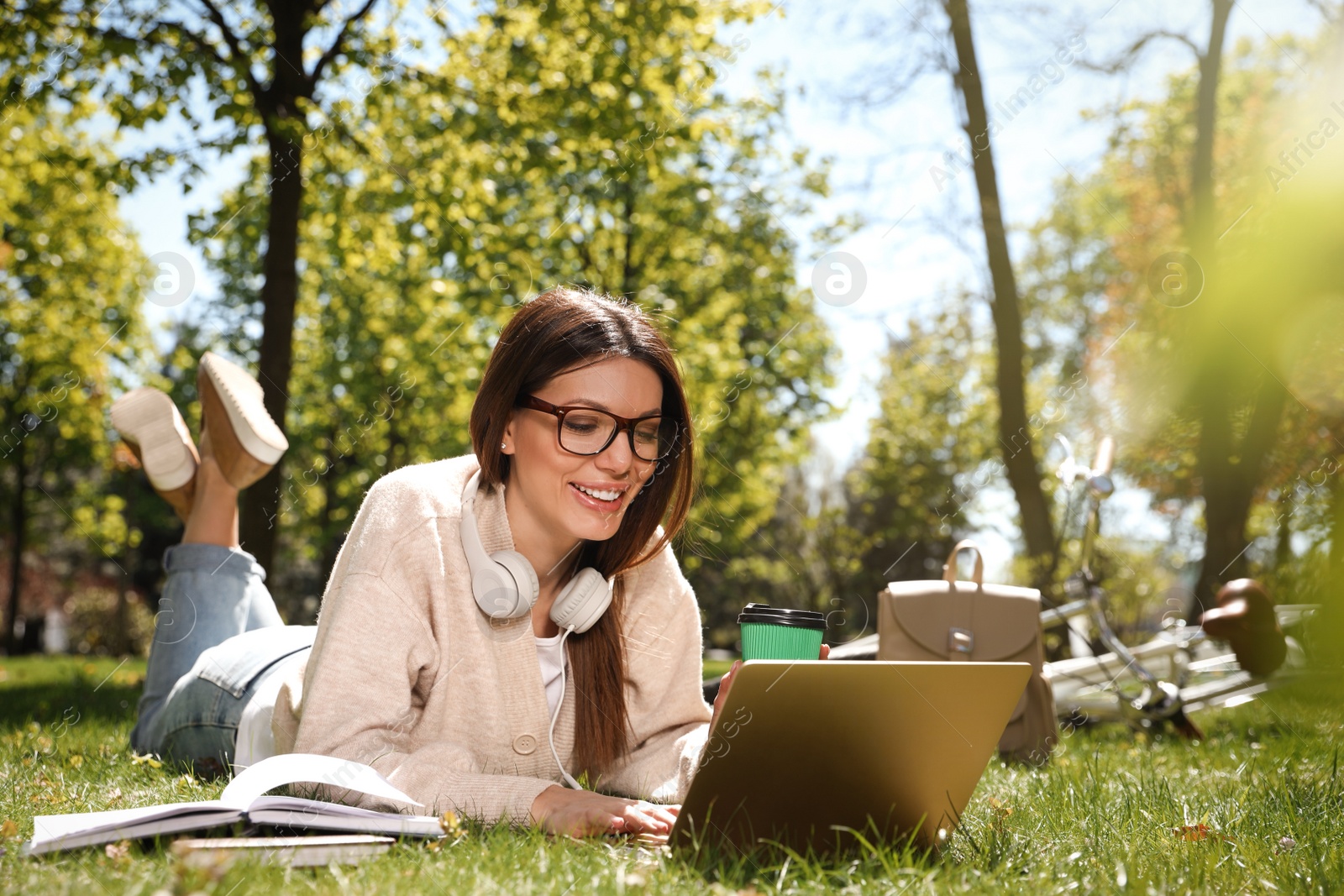 Photo of Beautiful woman working with laptop in park