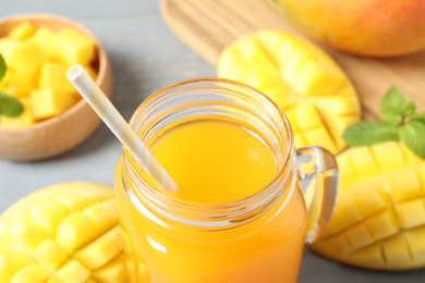 Photo of Fresh delicious mango drink on table, closeup