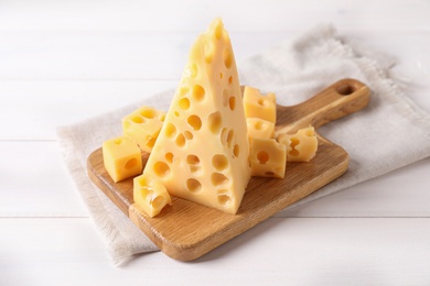 Photo of Tasty fresh cheese on white wooden table