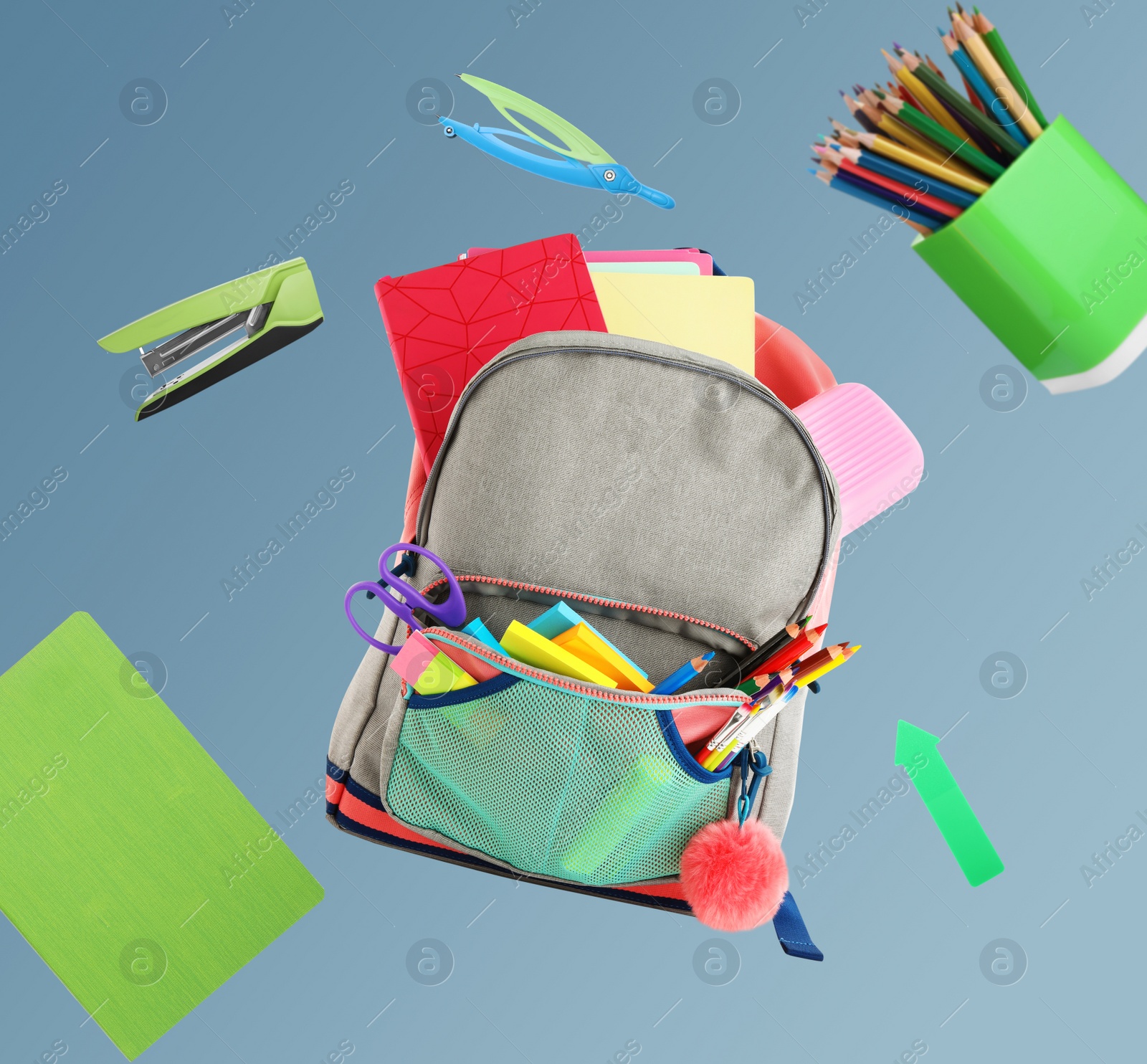 Image of Backpack surrounded by flying school stationery on color background