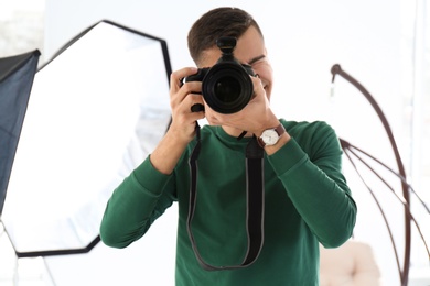 Young photographer working in professional studio