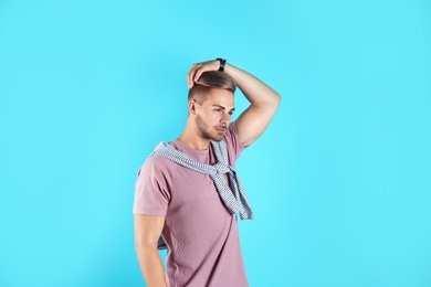 Photo of Young man with trendy hairstyle on color background