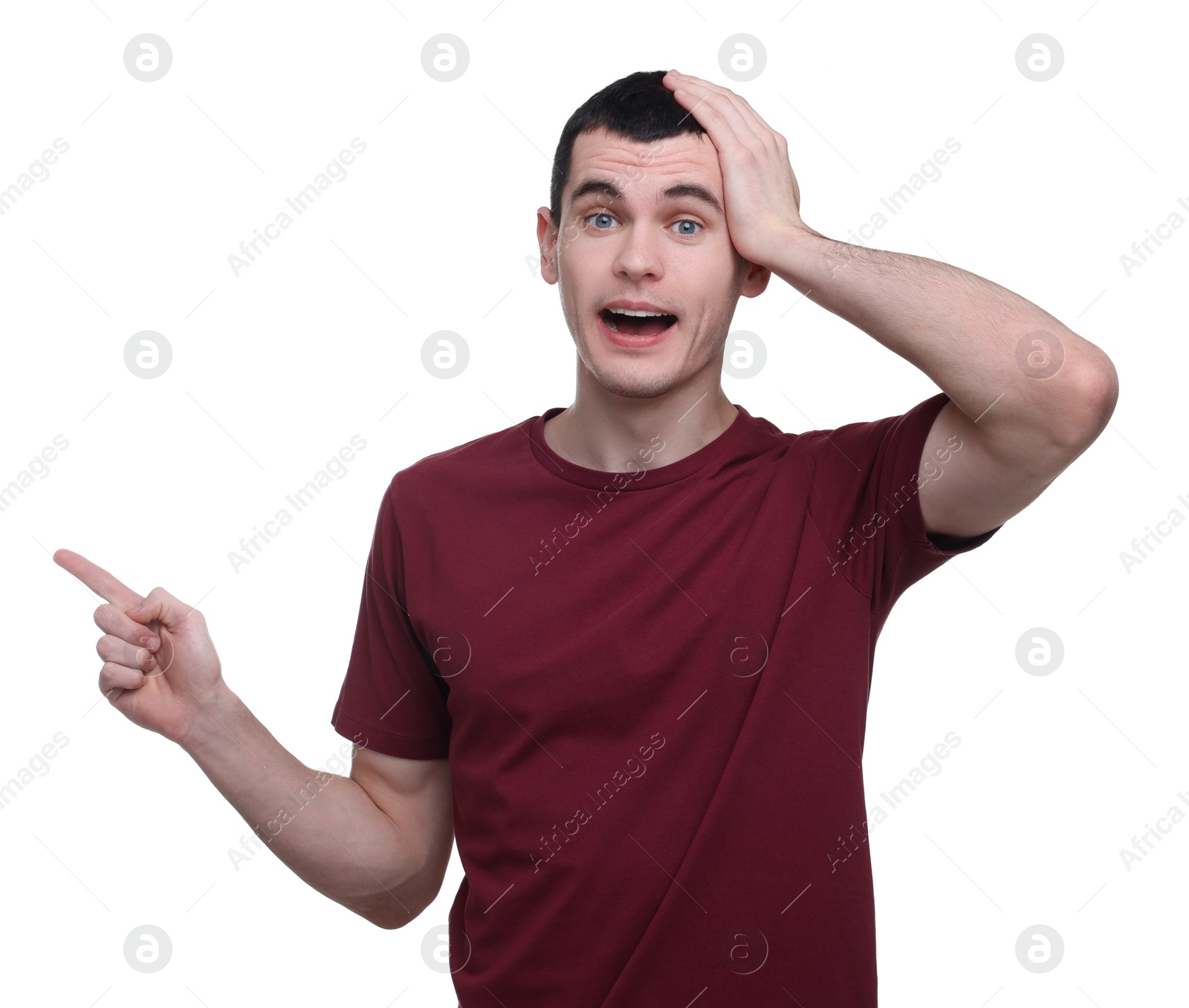 Photo of Surprised man pointing at something on white background