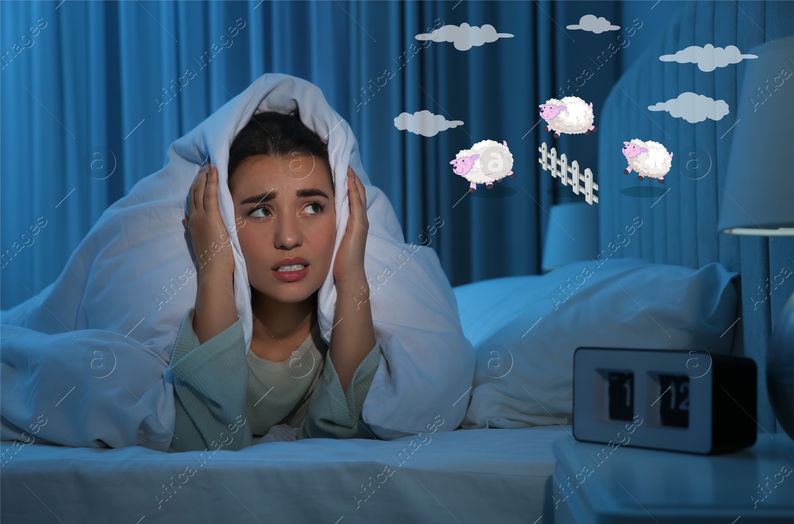 Image of Young woman trying to fall asleep counting sheep in bed at night