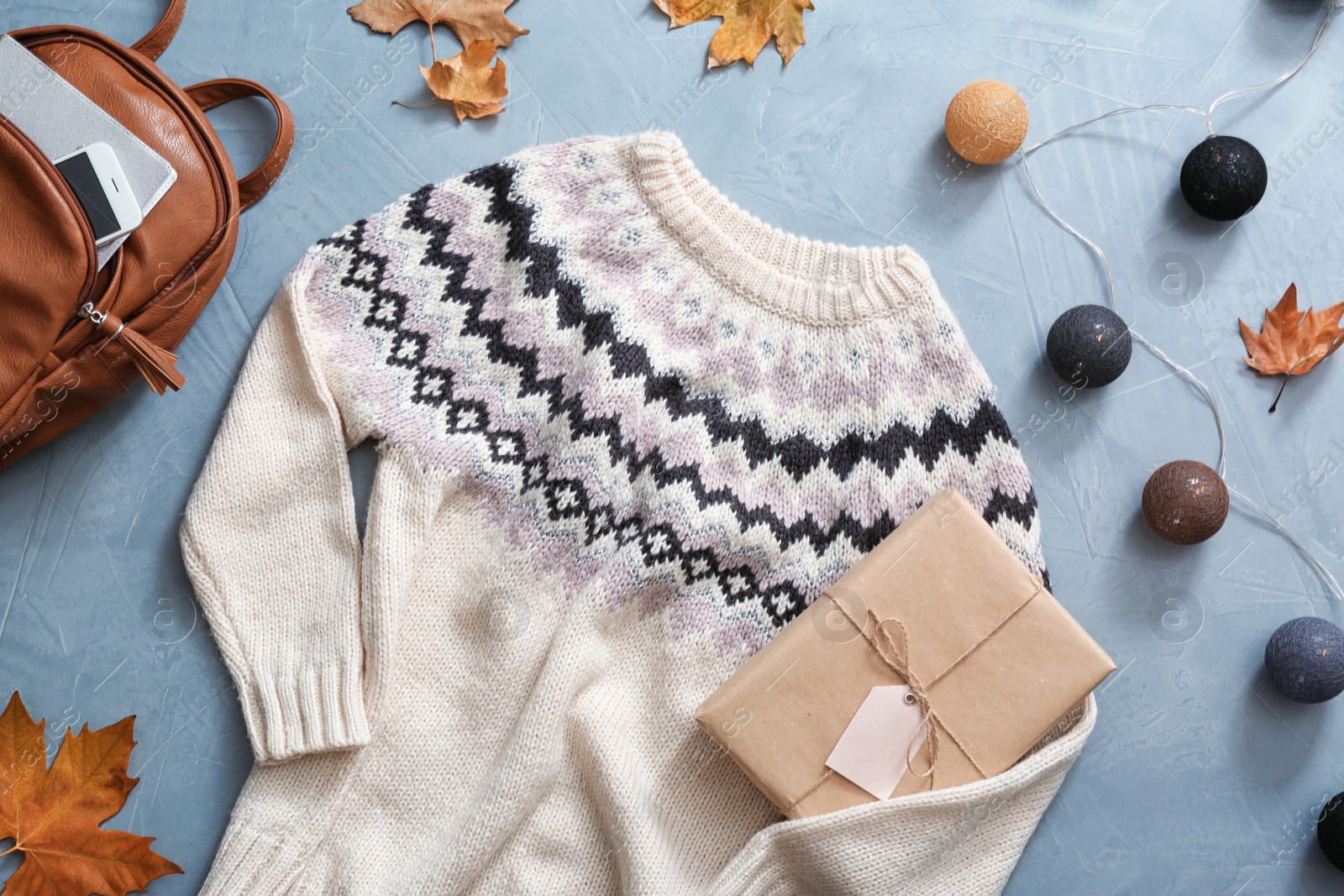 Photo of Flat lay composition with warm sweater on color background