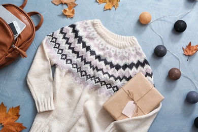 Photo of Flat lay composition with warm sweater on color background