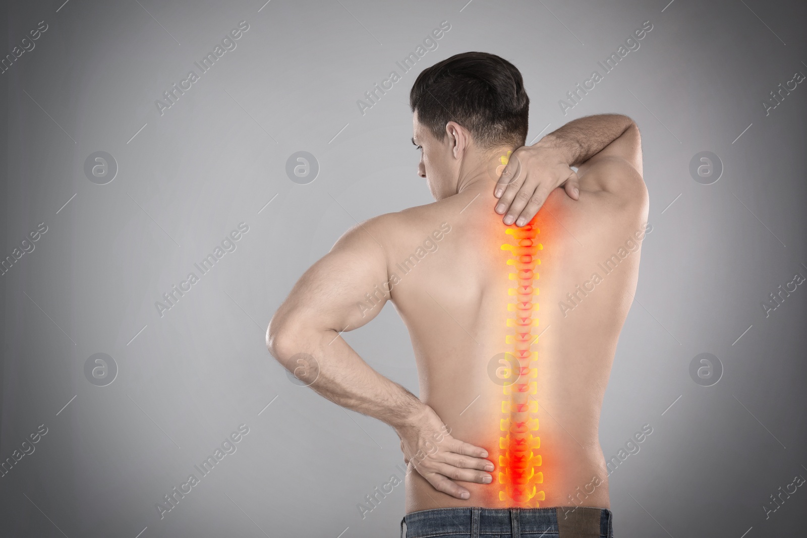 Image of Man suffering from pain in spine on grey background